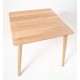 Square dining table or bistro table in a retro mid century style with a rounded cornered flat top and oval profile legs