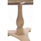 Round Dining Table with carved pedestal and triangular base and scroll feet in a stripped back wood finish
