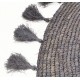 Hand woven circular rug with tassels on the edge in a dark grey to black colour
