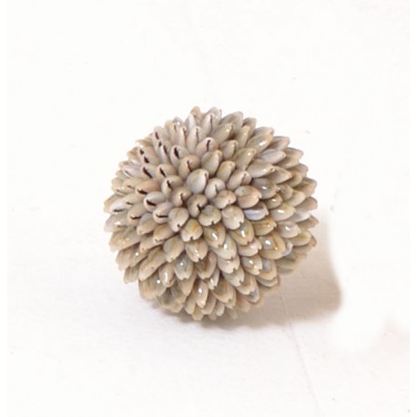 A decorative shell ball made with small conch type shells
