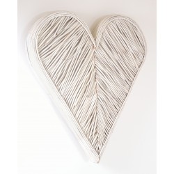 Woven rattan wall art in a 3d heart shape painted in a white finish
