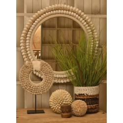 Round mirror with concentric circles of small light conch type shells on the frame